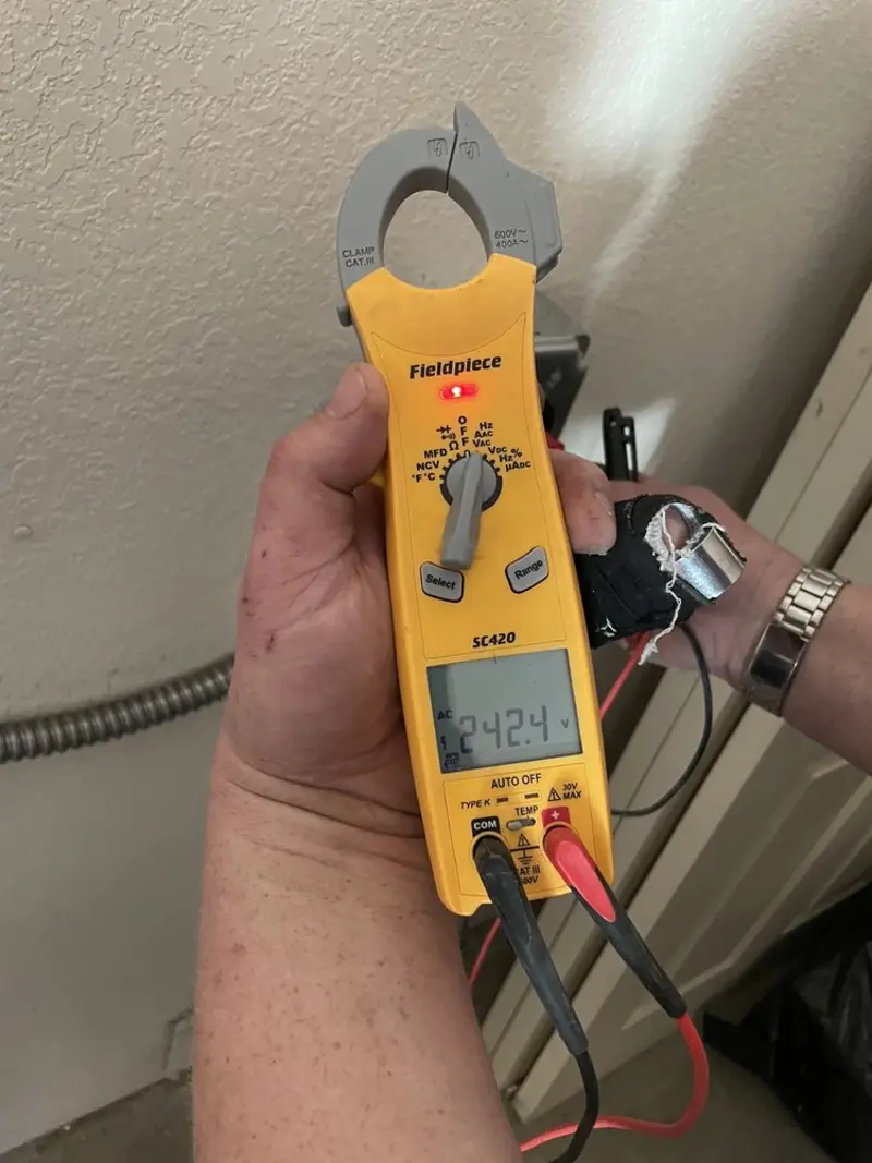 Voltage testing with clamp meter during Electrical Installation Services in Creve Coeur